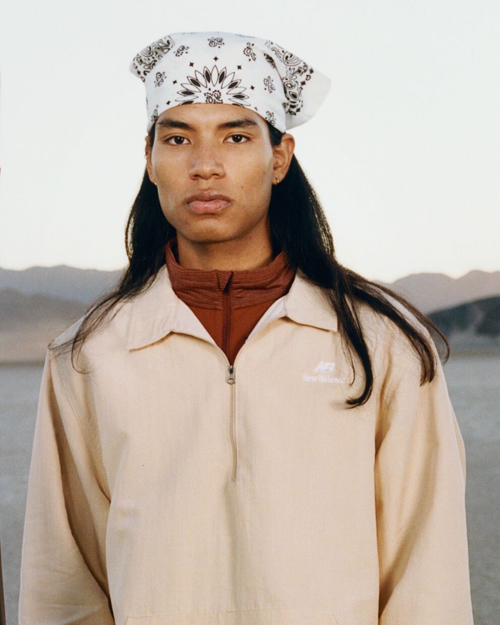 A woman standing against a barn backdrop. 