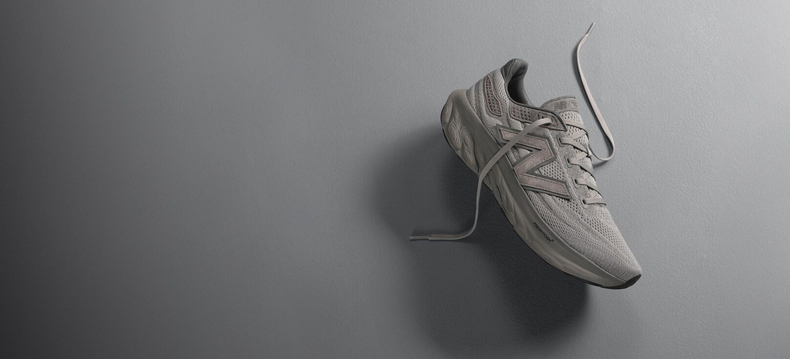A grey Fresh Foam 1080L laying on a grey background