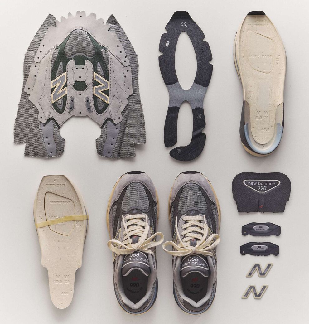 The 990v7 sneaker broken down into it's individual pieces laying on the ground.