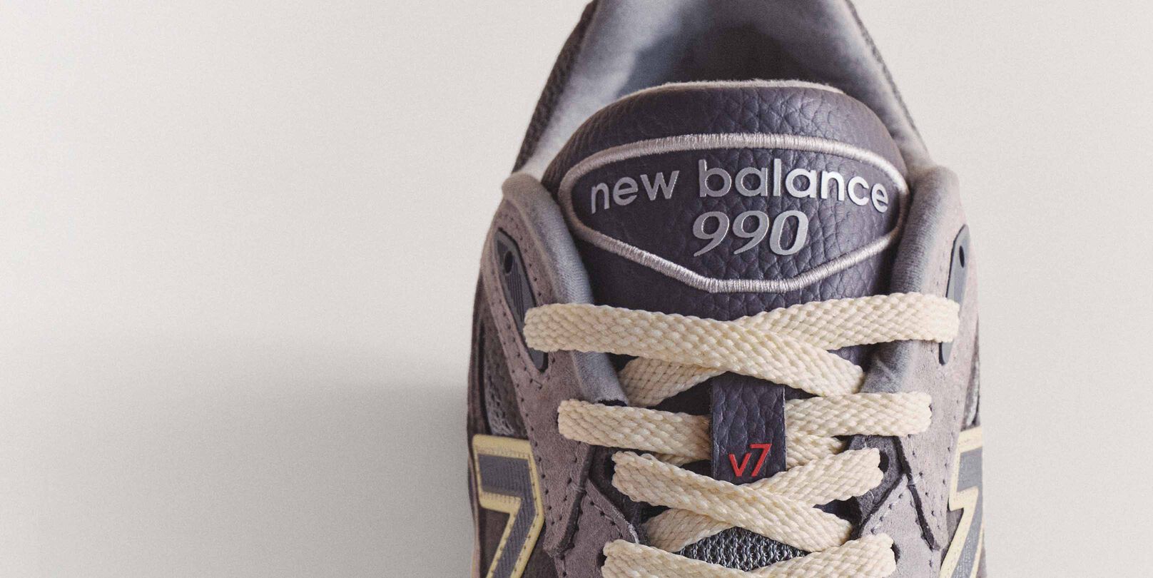 A close up image of the tongue of a 990v7 sneaker.