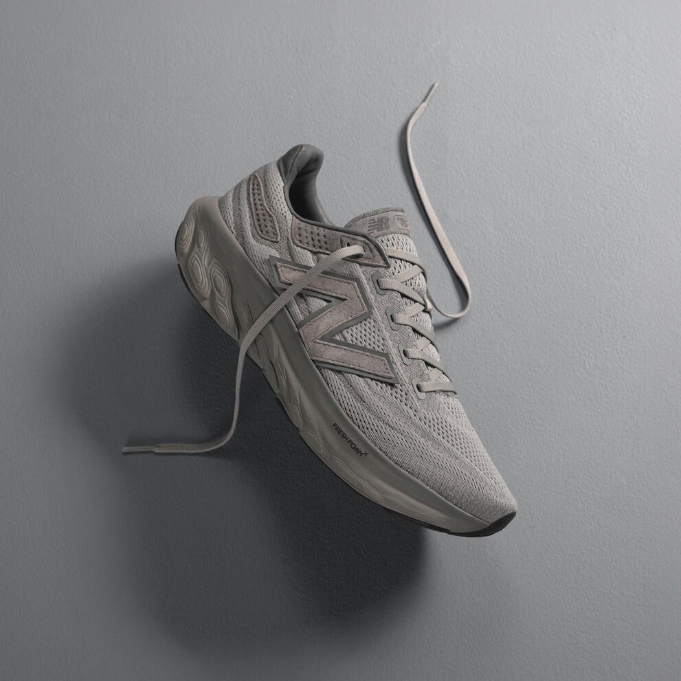 A grey Fresh Foam 1080L laying on a grey background